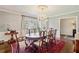 Formal dining room featuring hardwood floors, chandelier, and a large window with natural light at 1299 W Wesley Nw Rd, Atlanta, GA 30327