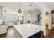Large kitchen island with seating, marble counters, and open view to kitchen and breakfast nook at 1299 W Wesley Nw Rd, Atlanta, GA 30327