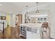 Spacious kitchen island with marble countertop, wine cooler, and stylish pendant lighting at 1299 W Wesley Nw Rd, Atlanta, GA 30327