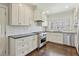 Well-appointed kitchen with stainless steel appliances, white cabinets, and dark countertops at 1299 W Wesley Nw Rd, Atlanta, GA 30327