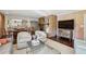 Living room showcasing a brick fireplace, modern furnishings, wood floors, and an open layout to the kitchen at 1299 W Wesley Nw Rd, Atlanta, GA 30327