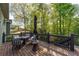 A covered back deck with an umbrella and a table with chairs provide outdoor relaxation at 2111 Democracy Dr, Buford, GA 30519