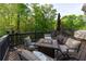 A wooden back deck furnished with neutral patio furniture is perfect for entertaining guests at 2111 Democracy Dr, Buford, GA 30519