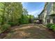 Large backyard with trees and greenery surrounding the home at 2111 Democracy Dr, Buford, GA 30519
