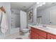 Well-lit bathroom with a shower-tub combo and a vanity sink at 2111 Democracy Dr, Buford, GA 30519