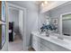 Bright bathroom featuring double sinks, a large mirror, and access to the bedroom at 2111 Democracy Dr, Buford, GA 30519