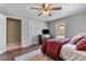 Comfortable bedroom boasts a ceiling fan, wood floors, and a cozy aesthetic at 2111 Democracy Dr, Buford, GA 30519