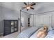 Comfortable bedroom featuring a four-poster bed, a dresser and a large window at 2111 Democracy Dr, Buford, GA 30519