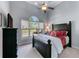 Comfortable bedroom showcasing a large window, ceiling fan, and stylish furnishings at 2111 Democracy Dr, Buford, GA 30519