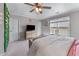 Well-lit bedroom features green accent wall, large window and a ceiling fan at 2111 Democracy Dr, Buford, GA 30519