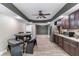 Basement kitchenette includes stainless appliances, custom cabinets, granite, and an adjacent dining space at 2111 Democracy Dr, Buford, GA 30519