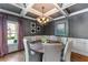Charming dining room with a round table, elegant chandelier, and views of the landscaped yard at 2111 Democracy Dr, Buford, GA 30519