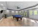 Entertain in this game room with a pool table, recessed lighting, and hardwood floors at 2111 Democracy Dr, Buford, GA 30519