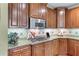 Updated kitchen featuring granite counters, stainless steel appliances, and custom cabinetry at 2111 Democracy Dr, Buford, GA 30519