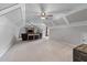 Bright living room features a sloped ceiling and two ceiling fans at 2111 Democracy Dr, Buford, GA 30519