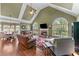 Inviting living room featuring vaulted ceilings, fireplace, hardwood floors, and arched windows at 2111 Democracy Dr, Buford, GA 30519