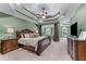 The main bedroom suite features a decorative trey ceiling, large window, and a ceiling fan at 2111 Democracy Dr, Buford, GA 30519