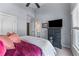 Bedroom with tall ceilings, large windows, and a TV over a dark-colored dresser at 2111 Democracy Dr, Buford, GA 30519
