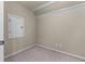 Carpeted room features neutral tones and an attic access door at 2111 Democracy Dr, Buford, GA 30519
