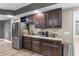 A modern wet bar features custom cabinets, granite countertops, stainless steel appliances, and a sink at 2111 Democracy Dr, Buford, GA 30519