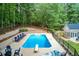Aerial view of expansive pool area with diving board, surrounded by lounge chairs and lush trees at 436 Westlake Nw Dr, Marietta, GA 30064