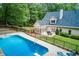 Aerial view of backyard with a large pool, lounge area, and a backdrop of lush trees at 436 Westlake Nw Dr, Marietta, GA 30064