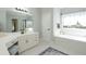 Well-lit bathroom with vanity, separate tub, and modern fixtures at 436 Westlake Nw Dr, Marietta, GA 30064