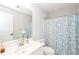 Well-lit bathroom with a white vanity, decorative shower curtain, toilet, and large mirror at 436 Westlake Nw Dr, Marietta, GA 30064