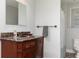 Bathroom vanity features bronze hardware, a marble countertop, decorative accents, and a mirror at 436 Westlake Nw Dr, Marietta, GA 30064