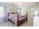 Neutral bedroom featuring a ceiling fan, a dark wood bed frame and decoratively draped curtains at 436 Westlake Nw Dr, Marietta, GA 30064