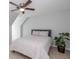 Neutral bedroom with a ceiling fan, a gray upholstered headboard, and a potted green plant at 436 Westlake Nw Dr, Marietta, GA 30064
