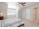 Bright bedroom includes a neutral palette, ceiling fan, and adjacent door to an en suite bathroom at 436 Westlake Nw Dr, Marietta, GA 30064
