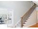 Bright foyer features staircase with decorative metal spindles and an adjacent doorway to an office space at 436 Westlake Nw Dr, Marietta, GA 30064