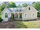 Charming home featuring a welcoming front porch, stone accents, and well-manicured lawn and manicured lawn at 436 Westlake Nw Dr, Marietta, GA 30064
