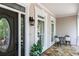 Charming covered front porch with stone flooring, elegant lighting, and comfortable seating area at 436 Westlake Nw Dr, Marietta, GA 30064