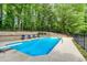 Inviting pool with diving board, surrounded by a patio, lounge chairs, and a lush treeline at 436 Westlake Nw Dr, Marietta, GA 30064