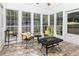 Bright sunroom with many large windows, tile flooring, comfortable seating, and cheerful decor at 436 Westlake Nw Dr, Marietta, GA 30064