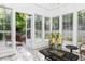 Bright sunroom features comfortable seating and access to backyard patio at 436 Westlake Nw Dr, Marietta, GA 30064