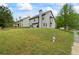 View of a lush, grassy backyard and the rear exterior of the house at 1205 Campbell Ridge Ln, Lawrenceville, GA 30045