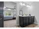 The bathroom features dual sinks, dark cabinets, a large mirror, and a view into the spacious bedroom at 1205 Campbell Ridge Ln, Lawrenceville, GA 30045