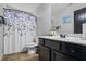 Bathroom with stylish vanity, tile flooring, and a shower with a decorative curtain at 1205 Campbell Ridge Ln, Lawrenceville, GA 30045