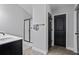 Stylish bathroom featuring a modern vanity, glass-enclosed shower, and sleek black doors for a touch of elegance at 1205 Campbell Ridge Ln, Lawrenceville, GA 30045