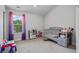 Bright bedroom features a window, plush carpet, and playful decor, creating a cozy and inviting space at 1205 Campbell Ridge Ln, Lawrenceville, GA 30045