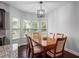 Well-lit dining area features a traditional wooden table, with views of the backyard at 1205 Campbell Ridge Ln, Lawrenceville, GA 30045