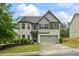 Charming two-story home with a brick facade, well-maintained landscaping, and an attached two-car garage at 1205 Campbell Ridge Ln, Lawrenceville, GA 30045