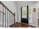 Hardwood floors lead to a black front door with sidelights, offering a bright and welcoming space at 1205 Campbell Ridge Ln, Lawrenceville, GA 30045