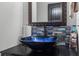 Close up of a vessel sink and vanity in a half bath with blue accent tile at 1205 Campbell Ridge Ln, Lawrenceville, GA 30045