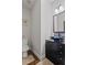 Stylish half bathroom with black vanity, vessel sink, decorative mirror, and accent tile at 1205 Campbell Ridge Ln, Lawrenceville, GA 30045
