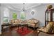 Formal living room with hardwood floors, wainscoting, tray ceiling, and elegant furniture at 1205 Campbell Ridge Ln, Lawrenceville, GA 30045