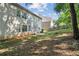 Backyard view of home with large grassy area and shade trees at 1520 Ethans Way, Mcdonough, GA 30252